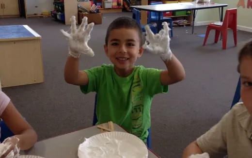 a boy holding a white object in his hand