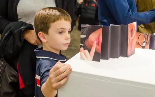 a boy looking at a book