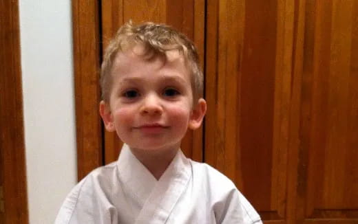 a boy smiling for the camera