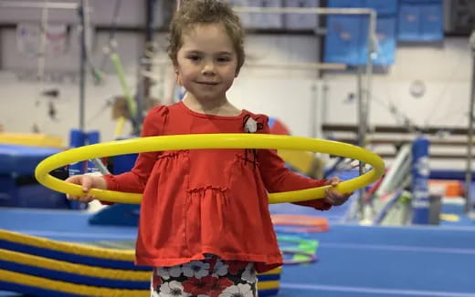 a child holding a yellow tube