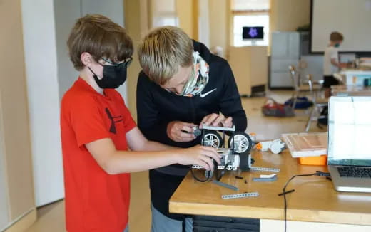 a couple of boys using a machine