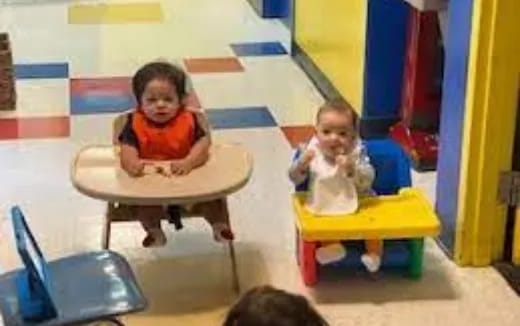 a couple of children sitting in chairs