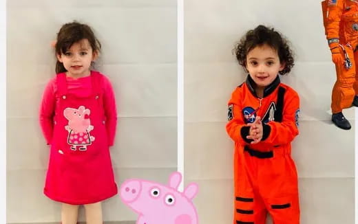 a couple of children wearing clothing