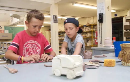 a couple of kids working on a project