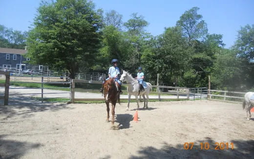 a couple of people riding horses