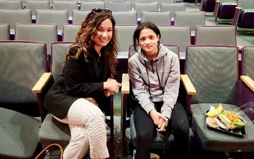 a couple of women sitting in chairs