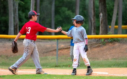 a couple of young boys playing baseball