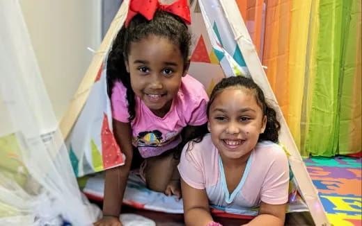 a couple of young girls smiling