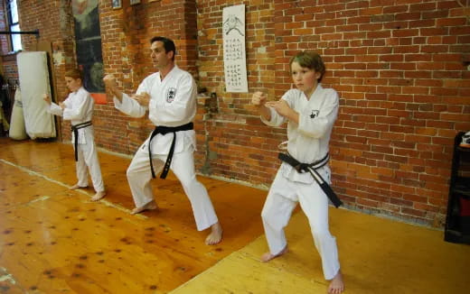 a group of boys in karate uniforms