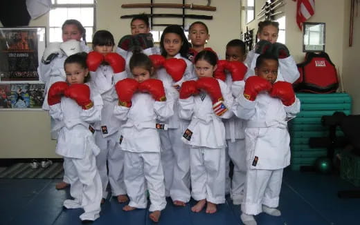 a group of children in white karate uniforms