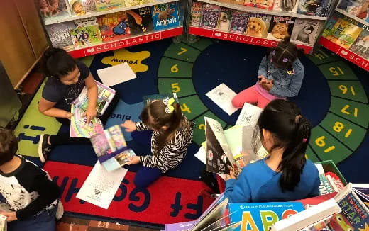 a group of children reading books