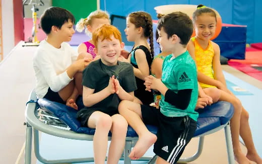 a group of children sitting on a chair