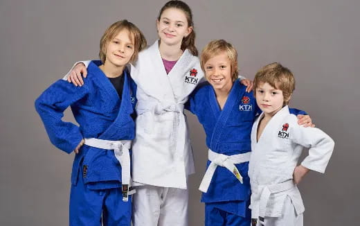 a group of girls in karate uniforms