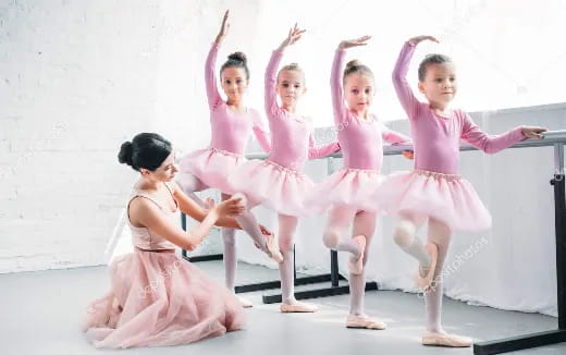 a group of girls in pink dresses