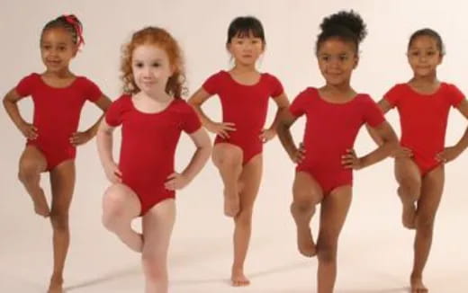 a group of girls in red dresses