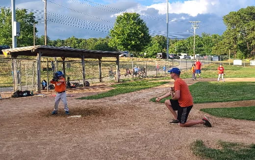 a group of kids playing baseball