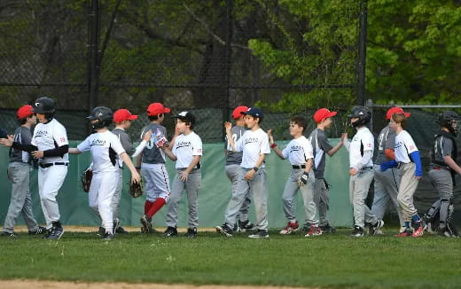 a group of kids playing baseball