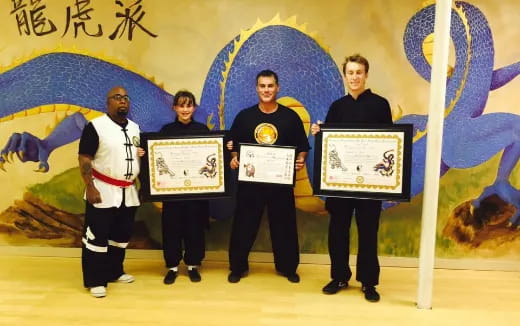 a group of men holding certificates