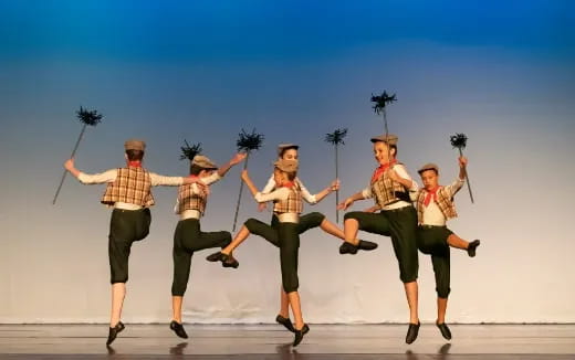 a group of men in clothing jumping