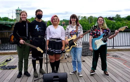 a group of people holding musical instruments