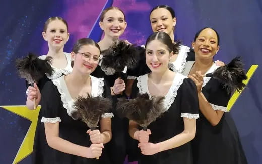 a group of people in black dresses