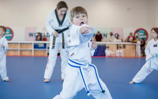 a group of people in karate uniforms