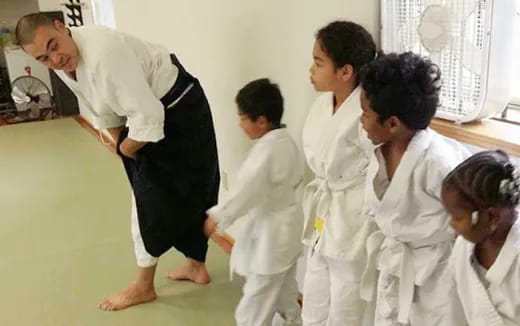 a group of people in white karate uniforms