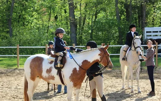 a group of people riding horses