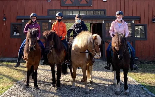 a group of people riding horses