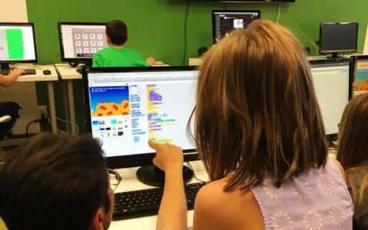 a group of people sitting at computers