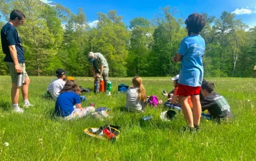 a group of people sitting on the grass