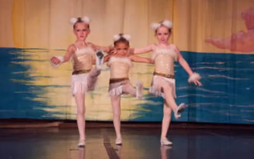 a group of women dancing on a stage