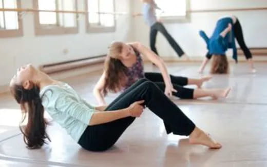 a group of women doing yoga