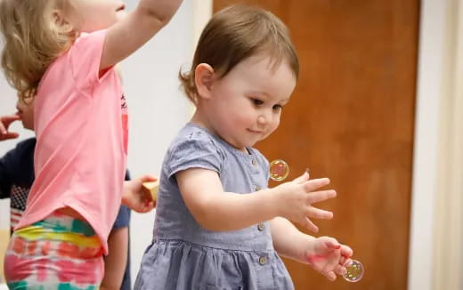 a little girl holding a bottle