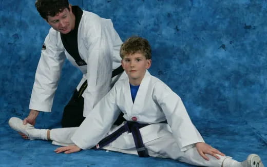 a man and a boy in karate uniforms