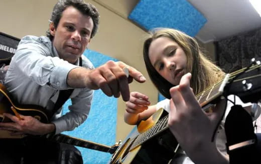 a man and a woman playing instruments