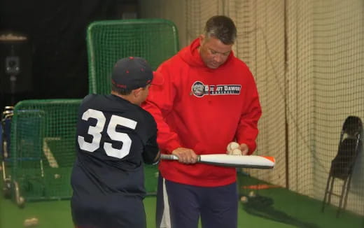 a man holding a baseball bat
