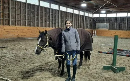 a man standing next to a horse