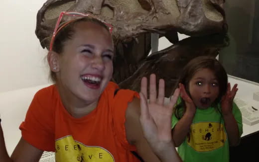 a person and a girl with their hands up