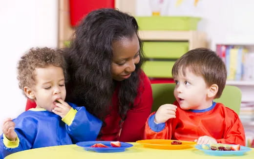 a person and two children eating