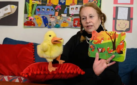 a person holding a stuffed duck