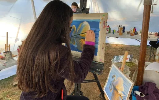 a person painting on a canvas