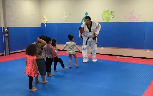 a person standing in front of a group of children