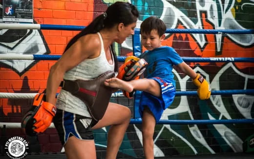 a woman and a boy playing in a swimming pool