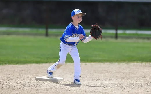 a young boy pitching a baseball