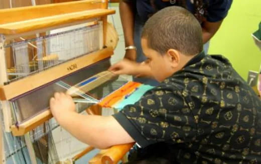 a young boy working on a machine