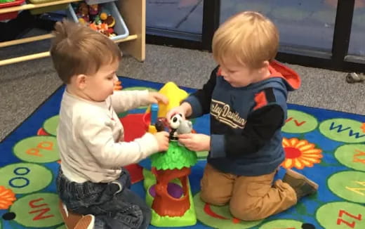 two boys playing with toys