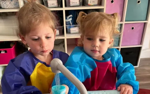 two children sitting at a table
