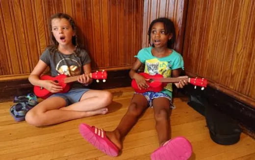 two girls sitting on the floor
