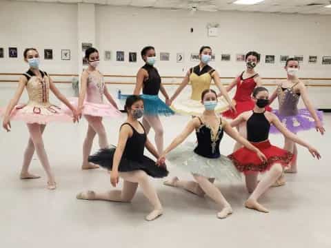 a group of women wearing dresses and dancing